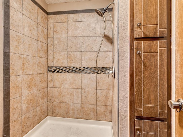 bathroom with a tile shower