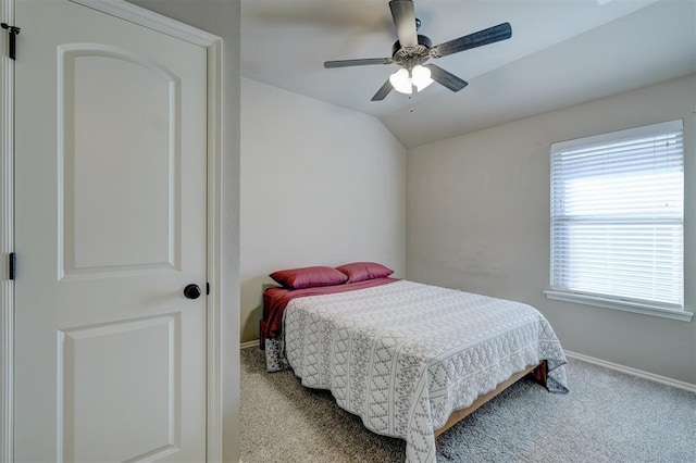 bedroom featuring ceiling fan, vaulted ceiling, and carpet