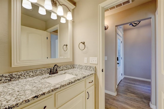 bathroom featuring vanity and wood-type flooring