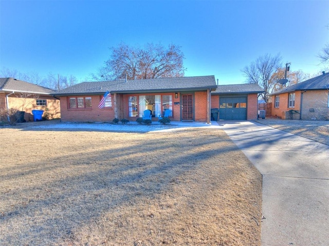 ranch-style home featuring a garage and a front yard