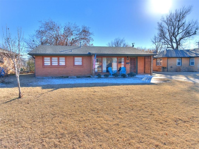 back of property featuring a lawn