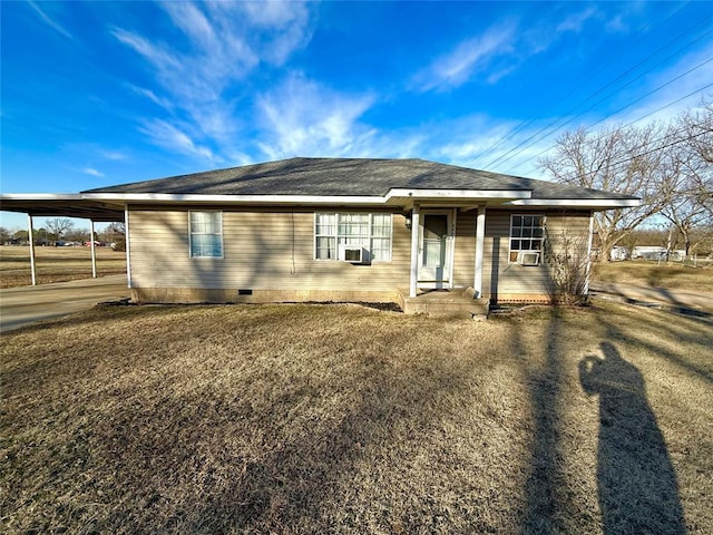 ranch-style home with cooling unit, a front yard, and a carport