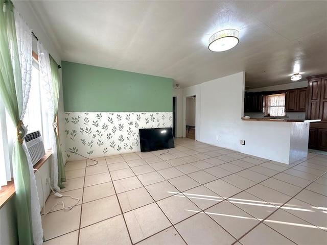 unfurnished living room with light tile patterned flooring