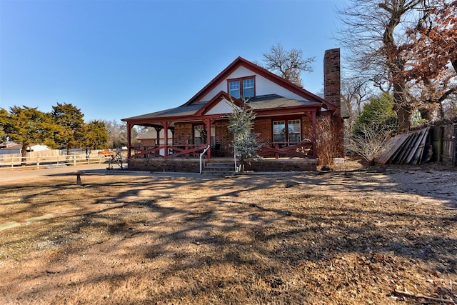 view of front of property with a front yard and covered porch