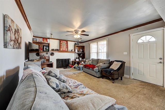 carpeted living room featuring crown molding, a brick fireplace, and ceiling fan