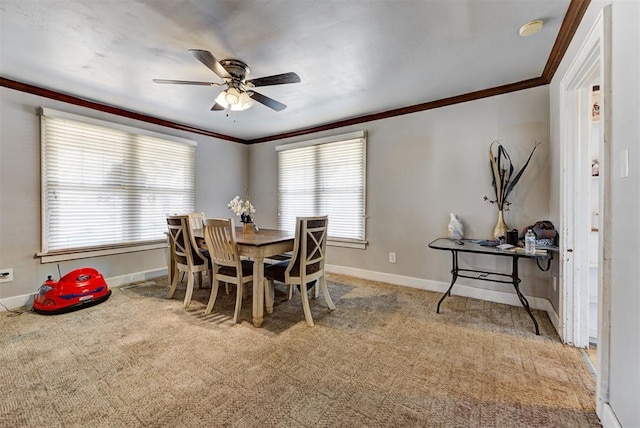 carpeted dining room with ornamental molding and ceiling fan