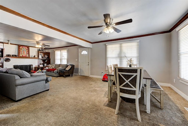 living room with ceiling fan, ornamental molding, a fireplace, and carpet floors