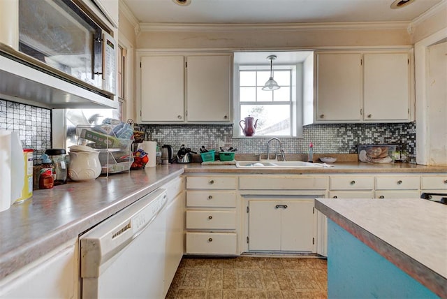 kitchen with tasteful backsplash, dishwasher, sink, and hanging light fixtures