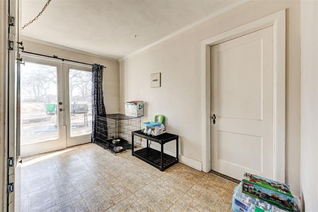 entryway featuring french doors and ornamental molding