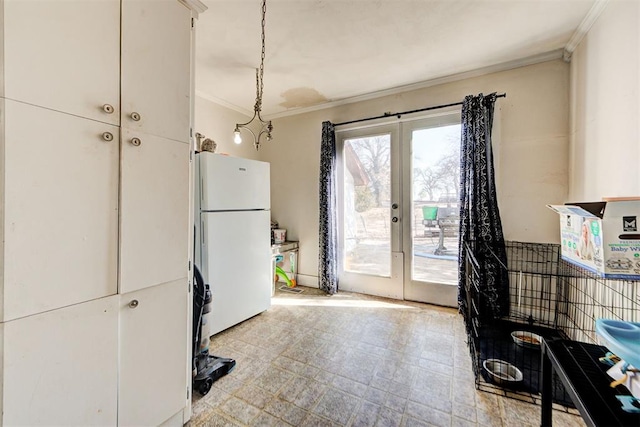 kitchen with ornamental molding, white fridge, decorative light fixtures, and french doors