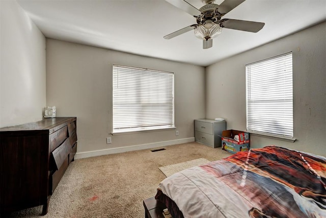 bedroom with ceiling fan and light carpet