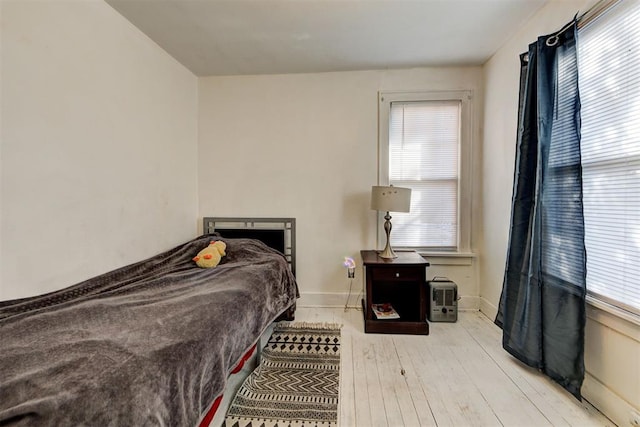 bedroom featuring light hardwood / wood-style floors and multiple windows