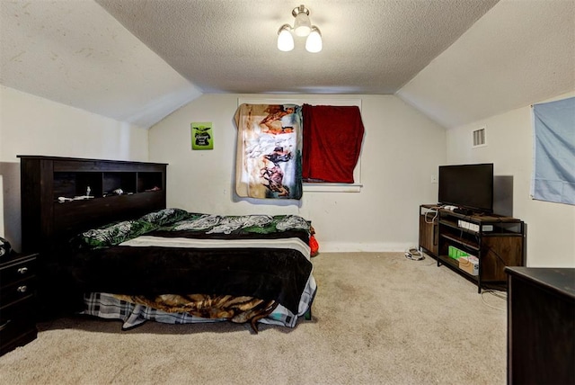 carpeted bedroom with lofted ceiling and a textured ceiling