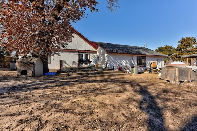 rear view of property featuring central air condition unit