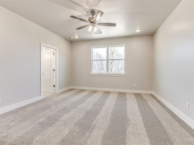 carpeted spare room with ceiling fan