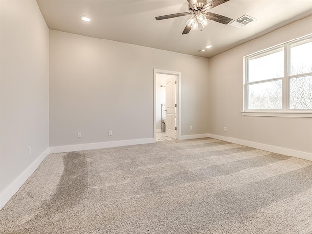 spare room with ceiling fan and carpet