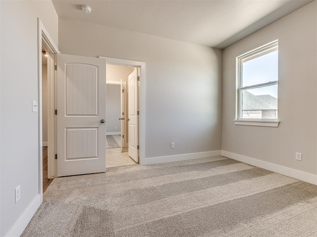 unfurnished bedroom with light colored carpet