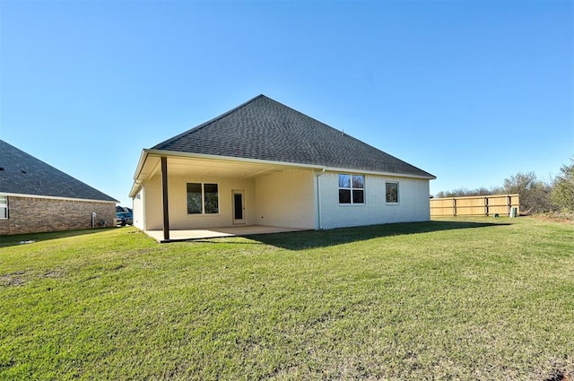 rear view of house with a yard and a patio