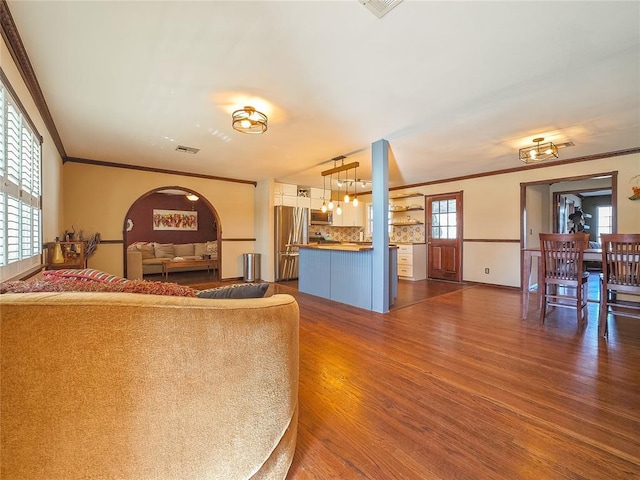 living room featuring dark wood-type flooring and crown molding