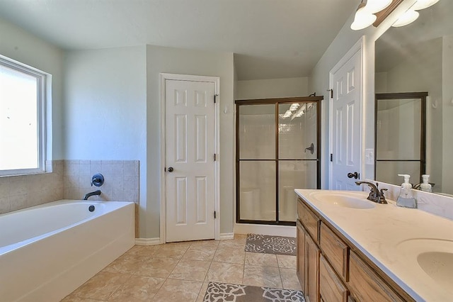 bathroom with tile patterned floors, separate shower and tub, and vanity