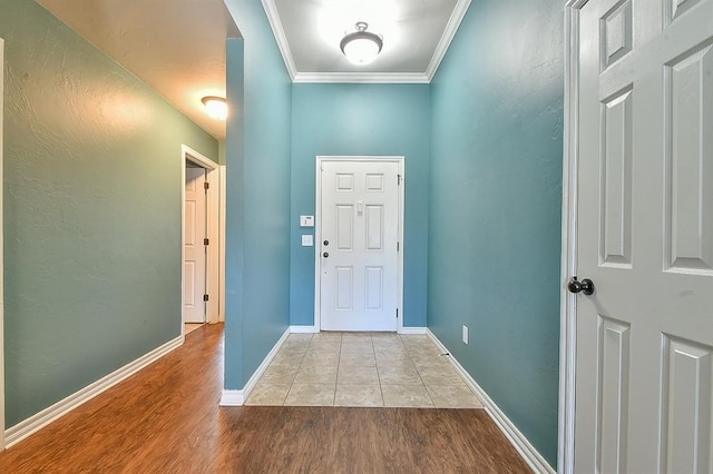 entrance foyer featuring ornamental molding and light hardwood / wood-style flooring