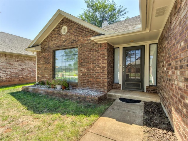 property entrance with a yard