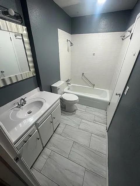 full bathroom with vanity, bathing tub / shower combination, and toilet