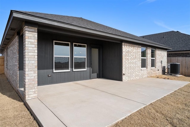 rear view of house featuring central AC unit and a patio area