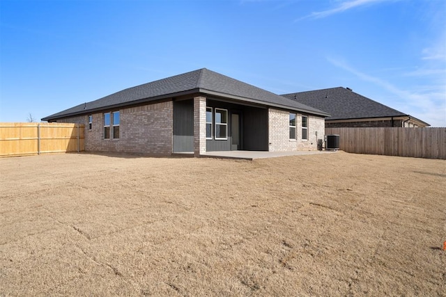 back of property with a patio area and central air condition unit