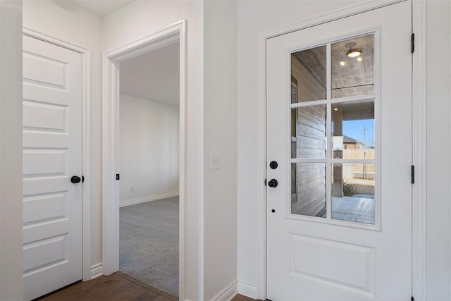 doorway to outside featuring carpet floors