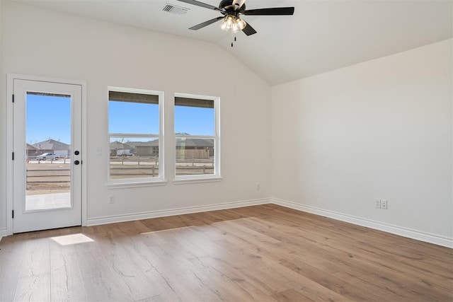 unfurnished room with ceiling fan, a healthy amount of sunlight, light hardwood / wood-style flooring, and lofted ceiling