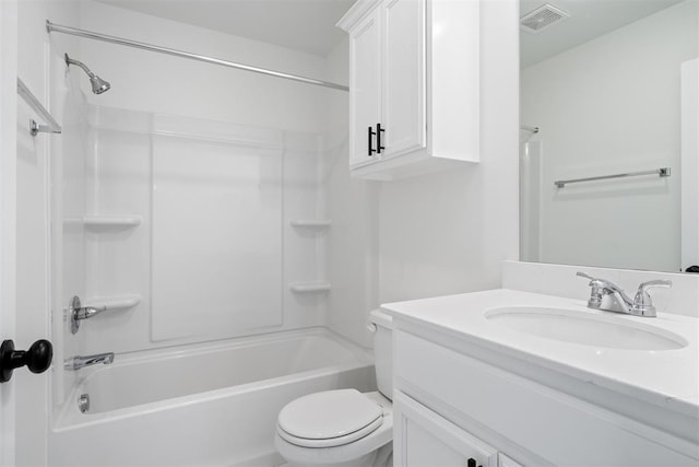 full bathroom featuring washtub / shower combination, vanity, and toilet