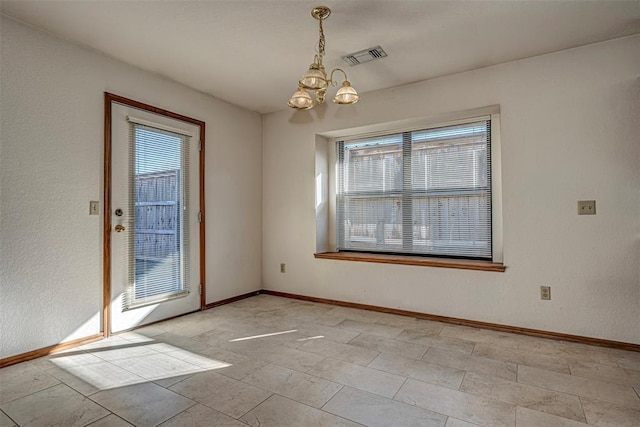 unfurnished dining area with a notable chandelier