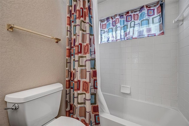 bathroom featuring shower / bath combination with curtain and toilet