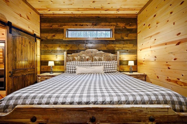 unfurnished bedroom with a barn door, wooden ceiling, and wood walls