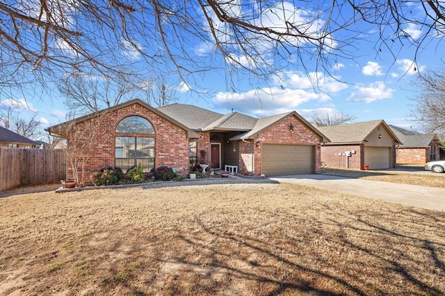 ranch-style home with a garage and a front lawn