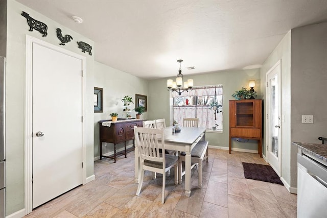 dining area with an inviting chandelier