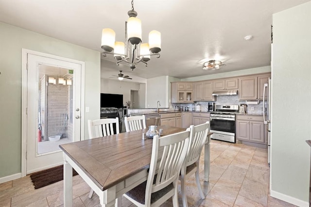 dining room featuring sink and a chandelier