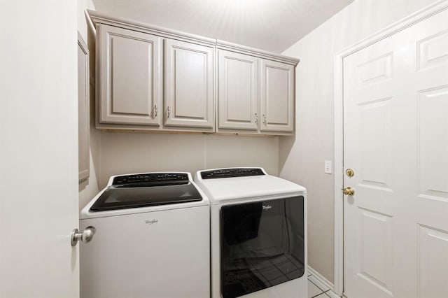 washroom featuring cabinets, independent washer and dryer, and light tile patterned flooring