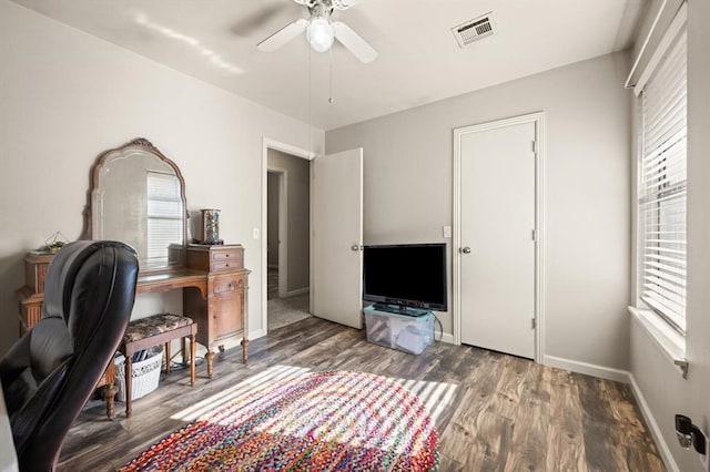 office area with dark wood-type flooring, a wealth of natural light, and ceiling fan