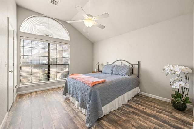 bedroom with multiple windows, dark hardwood / wood-style flooring, ceiling fan, and vaulted ceiling