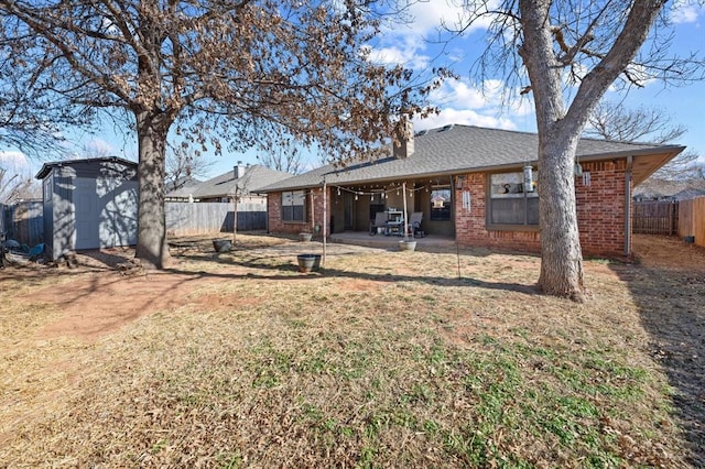 back of house featuring a storage shed and a patio