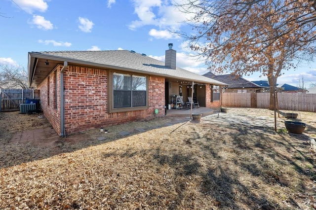 rear view of property with central AC and a patio