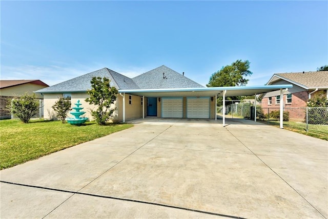 view of front of house with a garage and a front lawn