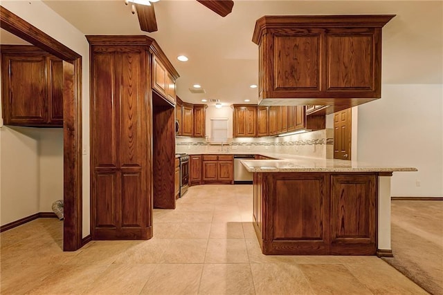 kitchen featuring appliances with stainless steel finishes, decorative backsplash, kitchen peninsula, light stone counters, and light tile patterned floors