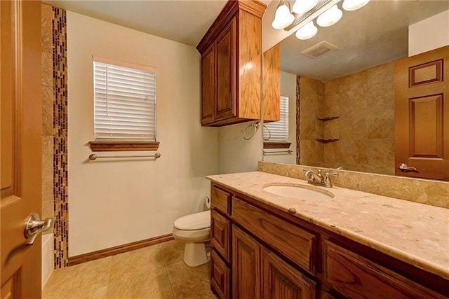 bathroom featuring vanity, toilet, a shower, and tile patterned floors