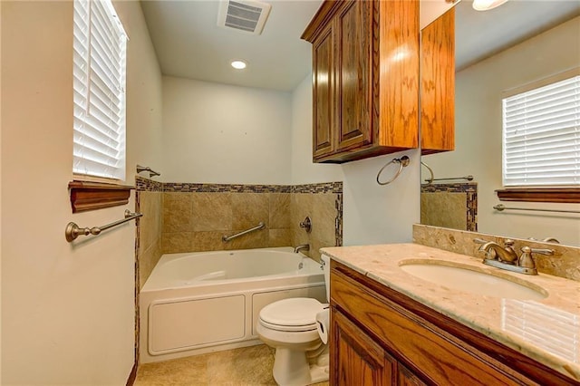 bathroom featuring toilet, a bath, vanity, and tile patterned flooring