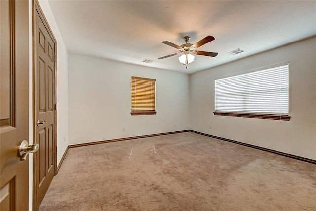 unfurnished room featuring ceiling fan and light colored carpet