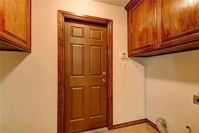 clothes washing area with cabinets and electric dryer hookup