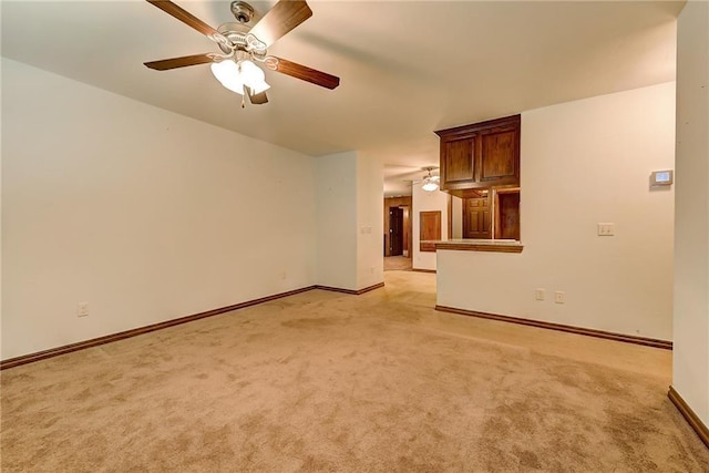 unfurnished living room with ceiling fan and light carpet